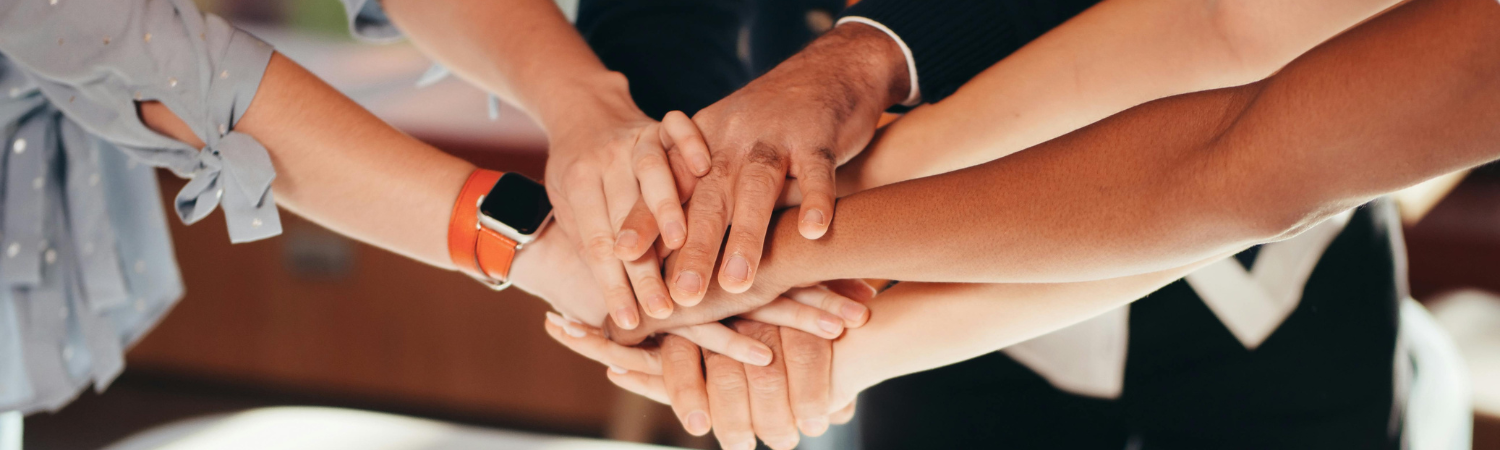 Group of hands stacked on top of each other.