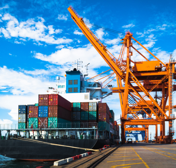 A large container ship is docked at the port