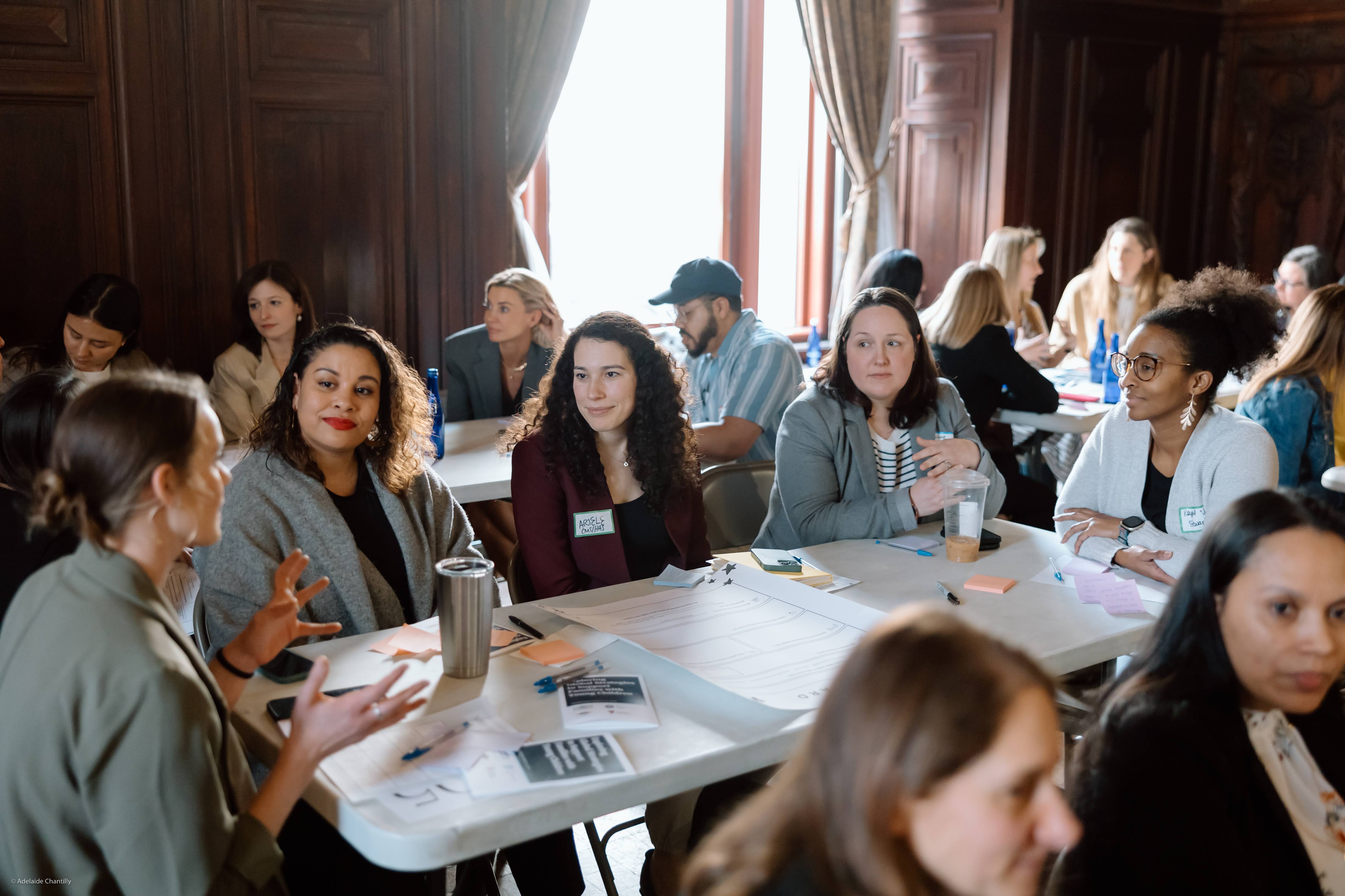 Workshop photo of women sitting at table during March 13 NYC event.